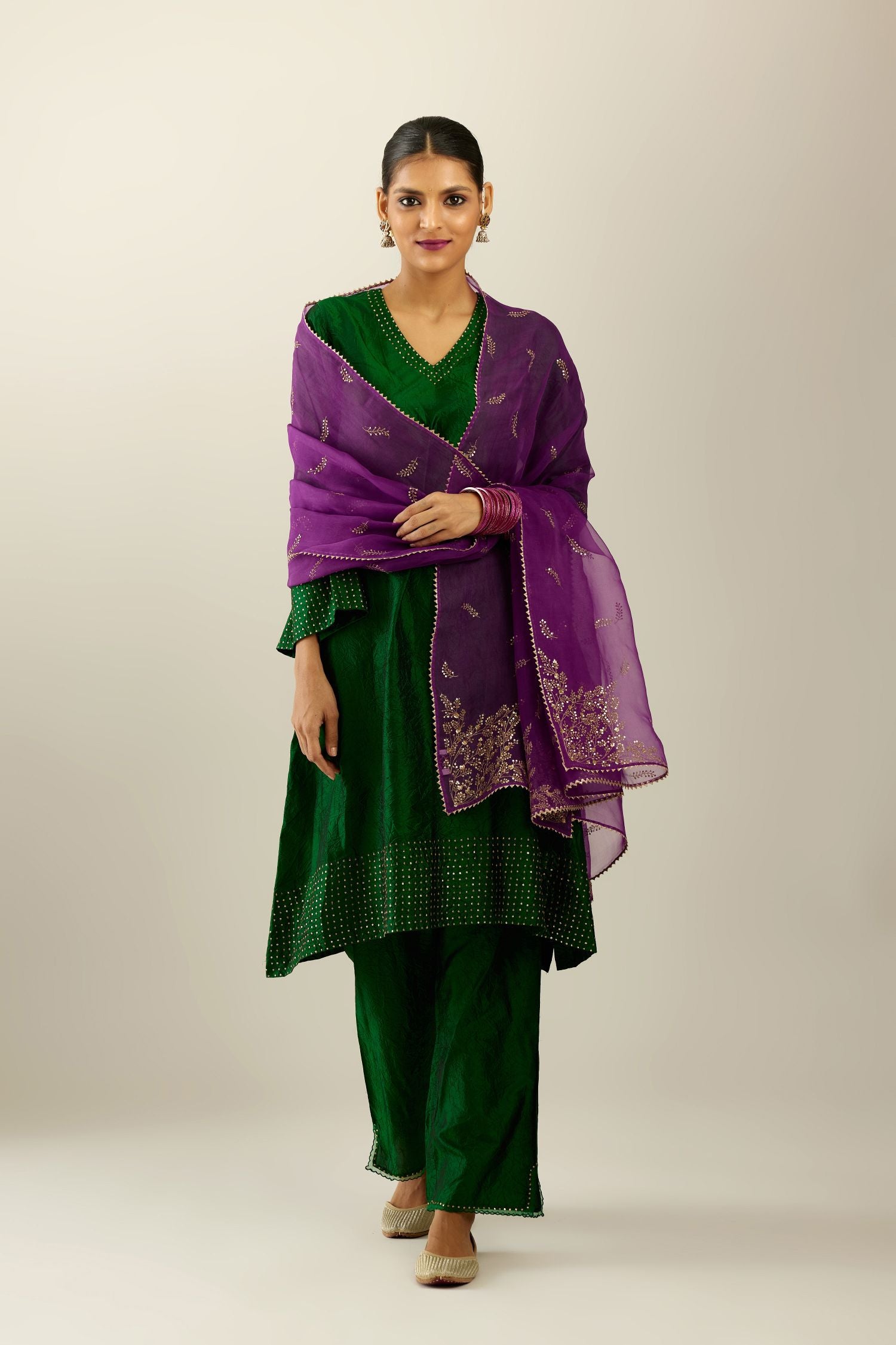 Dark green silk hand crushed easy fit straight hem kurta set, highlighted with a broad gold sequins border at hem.