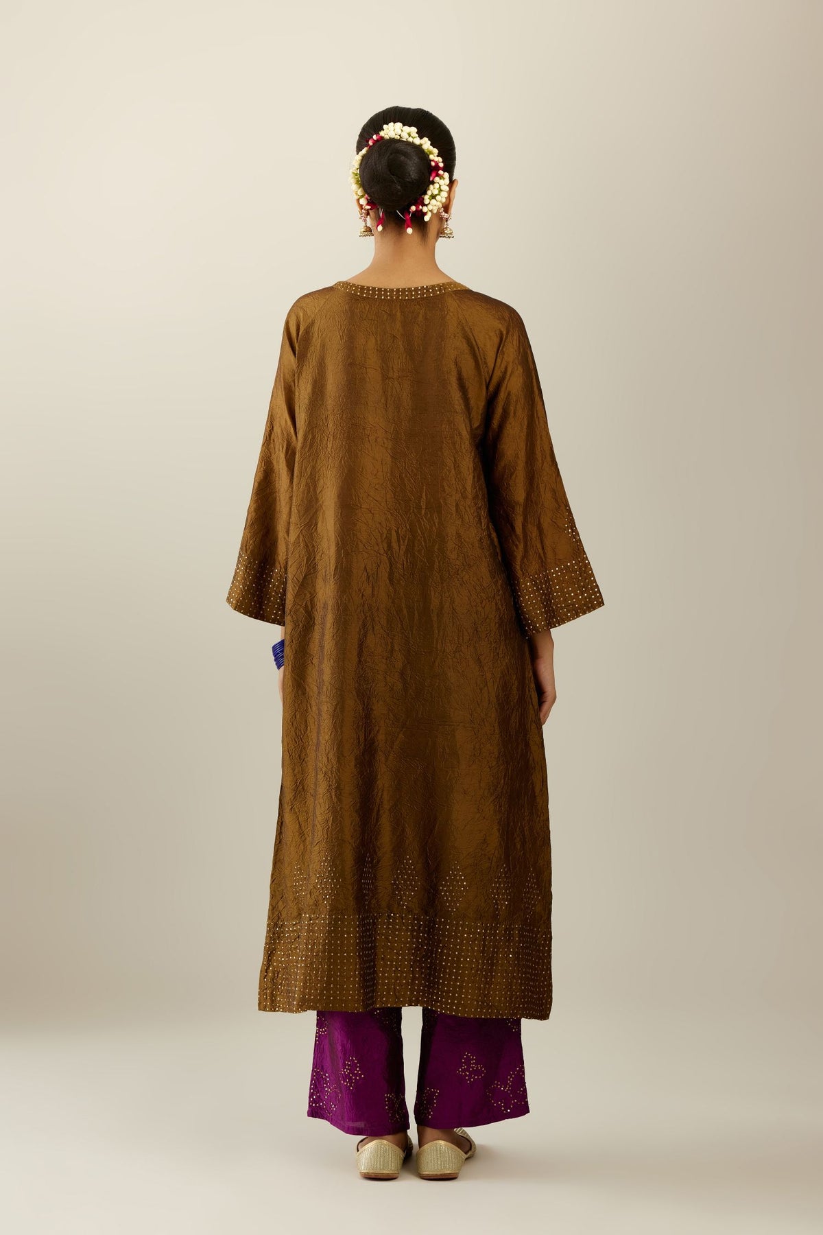 Golden olive silk hand crushed kurta set with concealed button placket neckline, highlighted with gold sequins heavy work at hem.