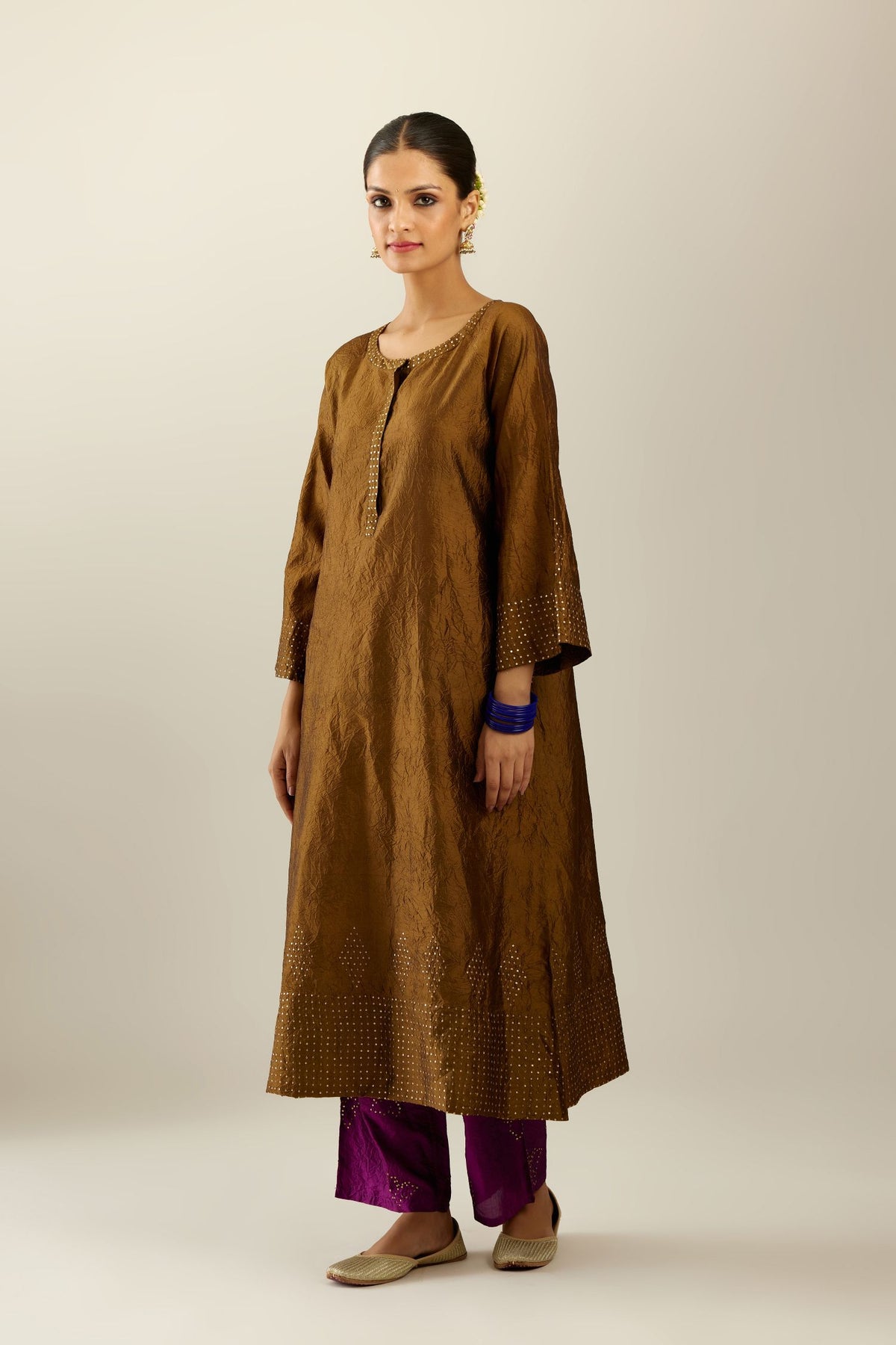 Golden olive silk hand crushed kurta set with concealed button placket neckline, highlighted with gold sequins heavy work at hem.