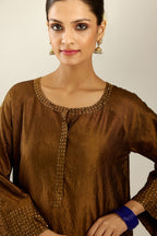 Golden olive silk hand crushed kurta set with concealed button placket neckline, highlighted with gold sequins heavy work at hem.