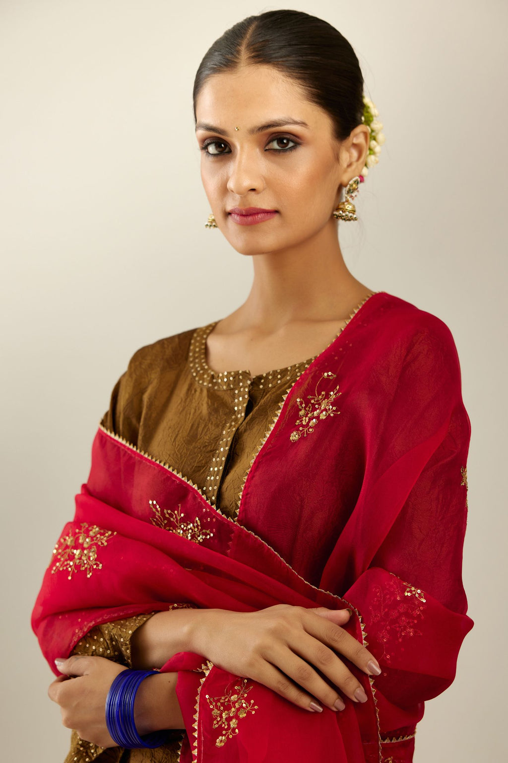 Golden olive silk hand crushed kurta set with concealed button placket neckline, highlighted with gold sequins heavy work at hem.