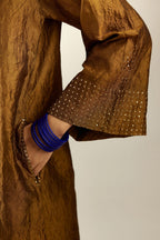Golden olive silk hand crushed kurta set with concealed button placket neckline, highlighted with gold sequins heavy work at hem.