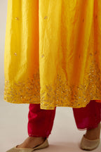 Yellow hand crushed silk kurta set with wavy empire waistline, gathers at waist and all-over gold sequins work detailing.