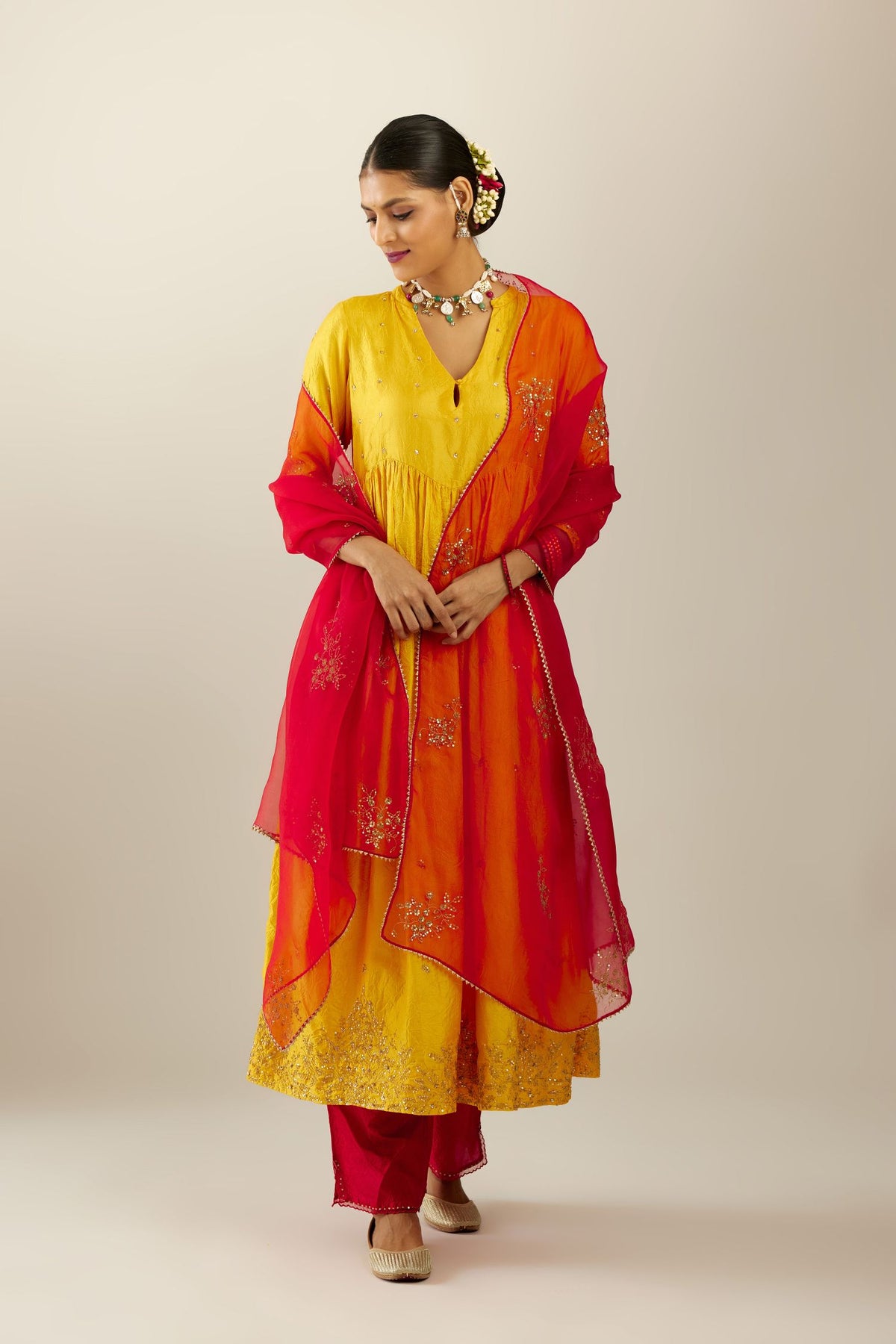 Yellow hand crushed silk kurta set with wavy empire waistline, gathers at waist and all-over gold sequins work detailing.