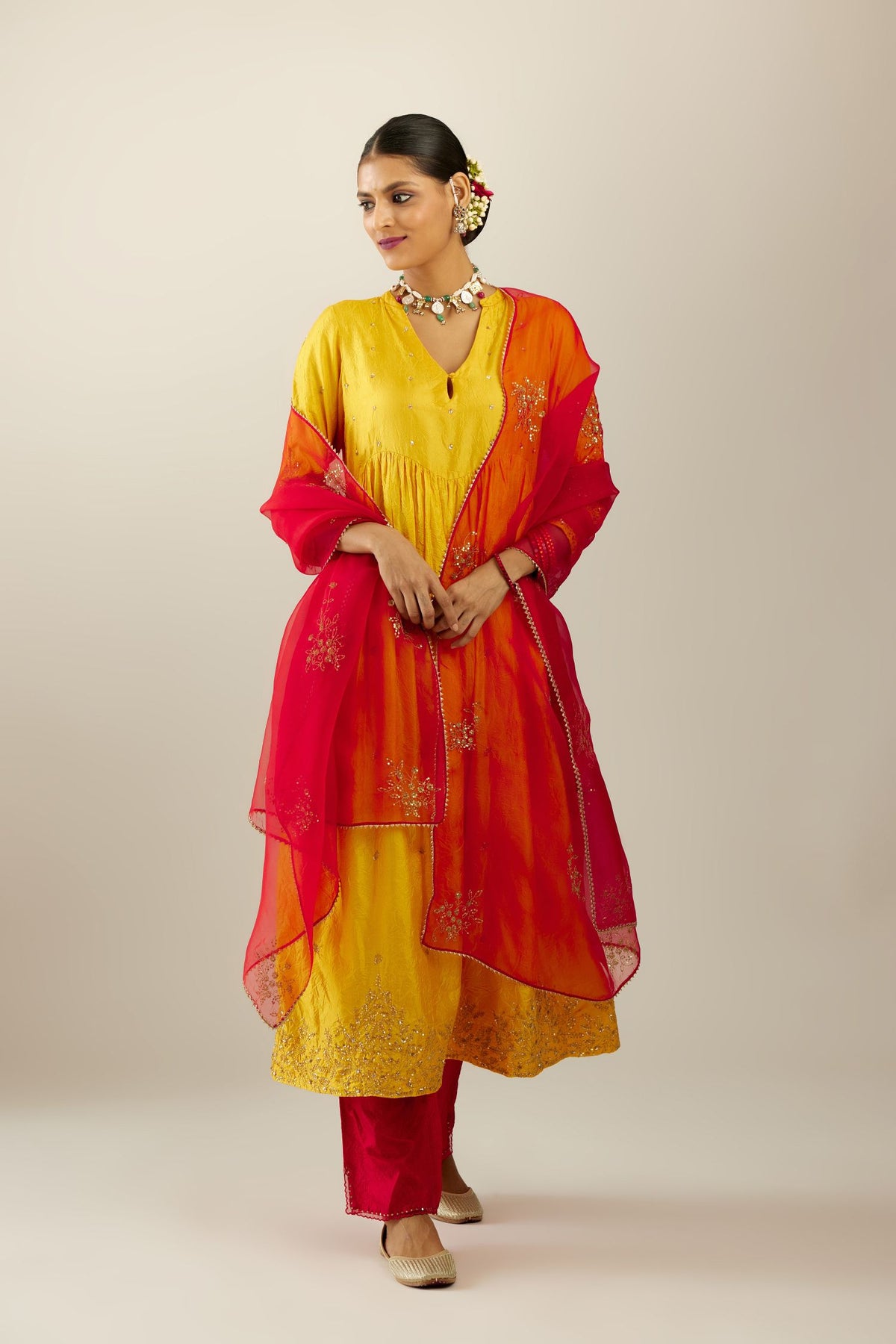 Yellow hand crushed silk kurta set with wavy empire waistline, gathers at waist and all-over gold sequins work detailing.