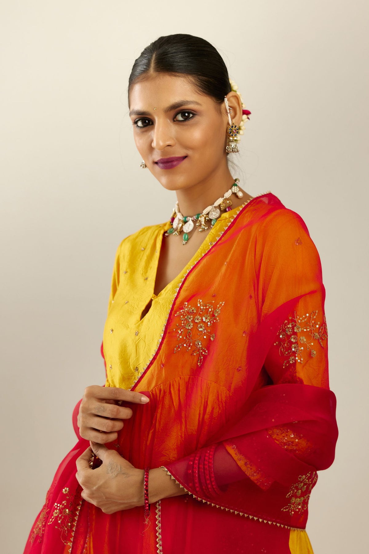 Yellow hand crushed silk kurta set with wavy empire waistline, gathers at waist and all-over gold sequins work detailing.