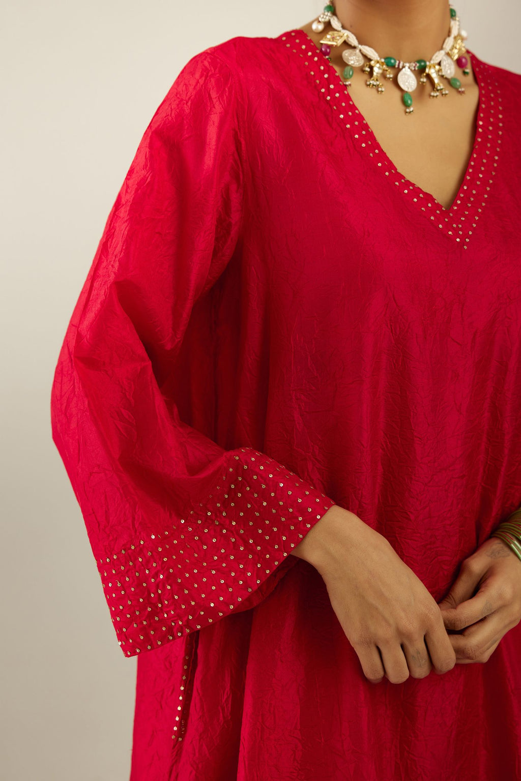 Red silk hand crushed easy fit straight hem kurta set, highlighted with a broad gold sequins border at hem