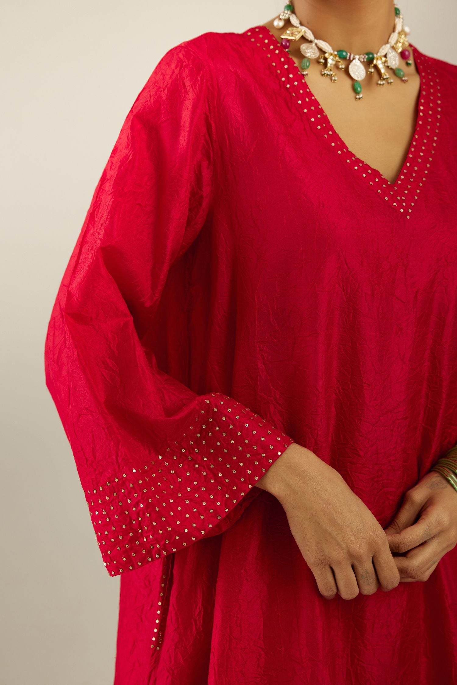 Red silk hand crushed easy fit straight hem kurta set, highlighted with a broad gold sequins border at hem