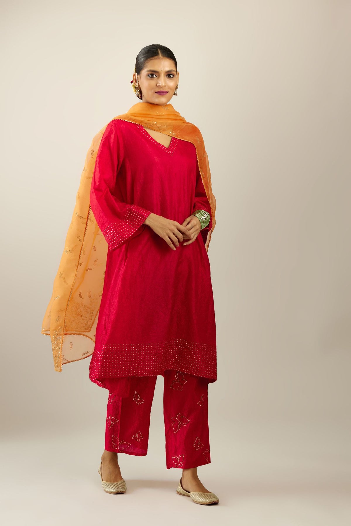Red silk hand crushed easy fit straight hem kurta set, highlighted with a broad gold sequins border at hem