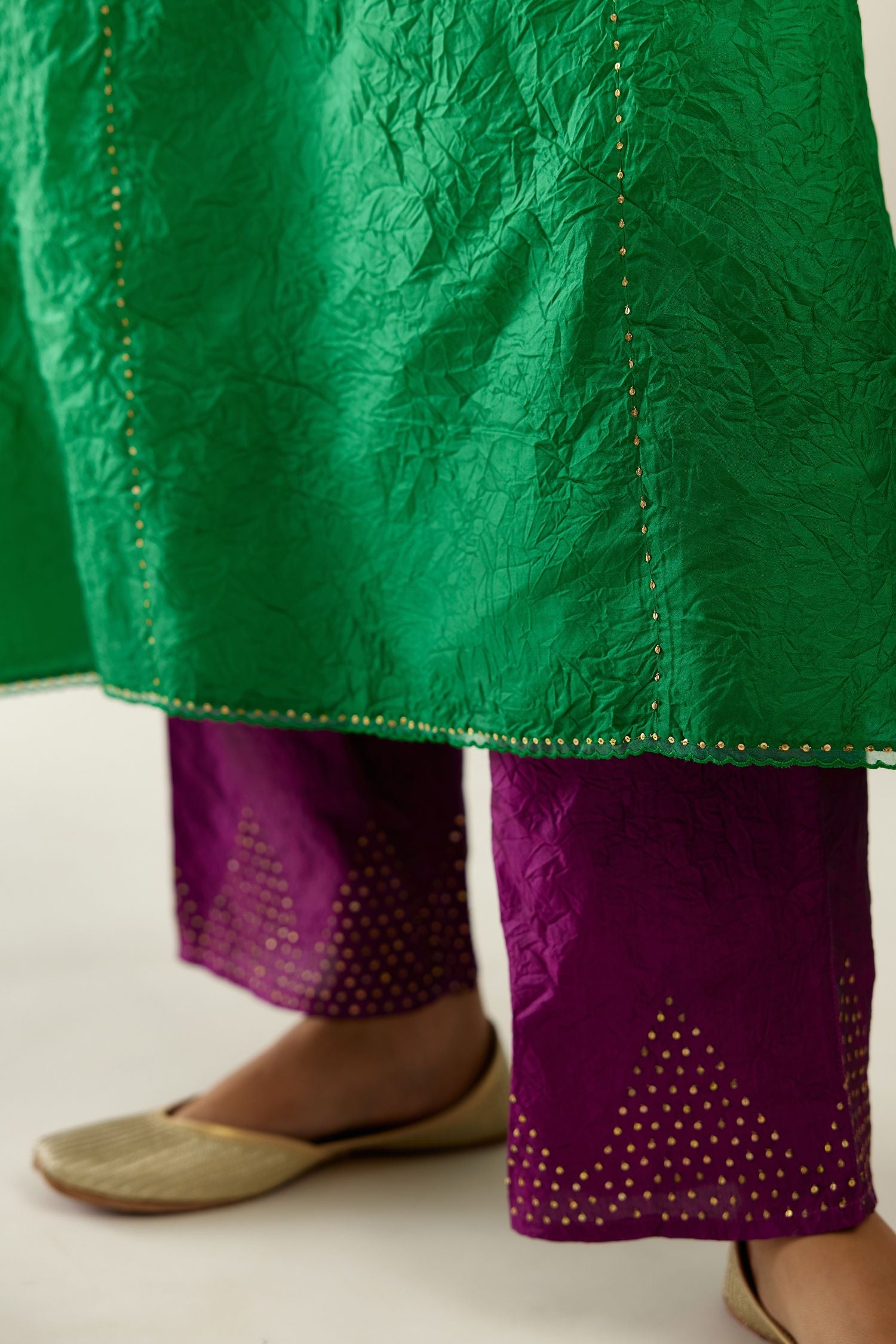 Silk hand crushed A-line kurta set, highlighted with gold sequins and embroidered scalloped edges.