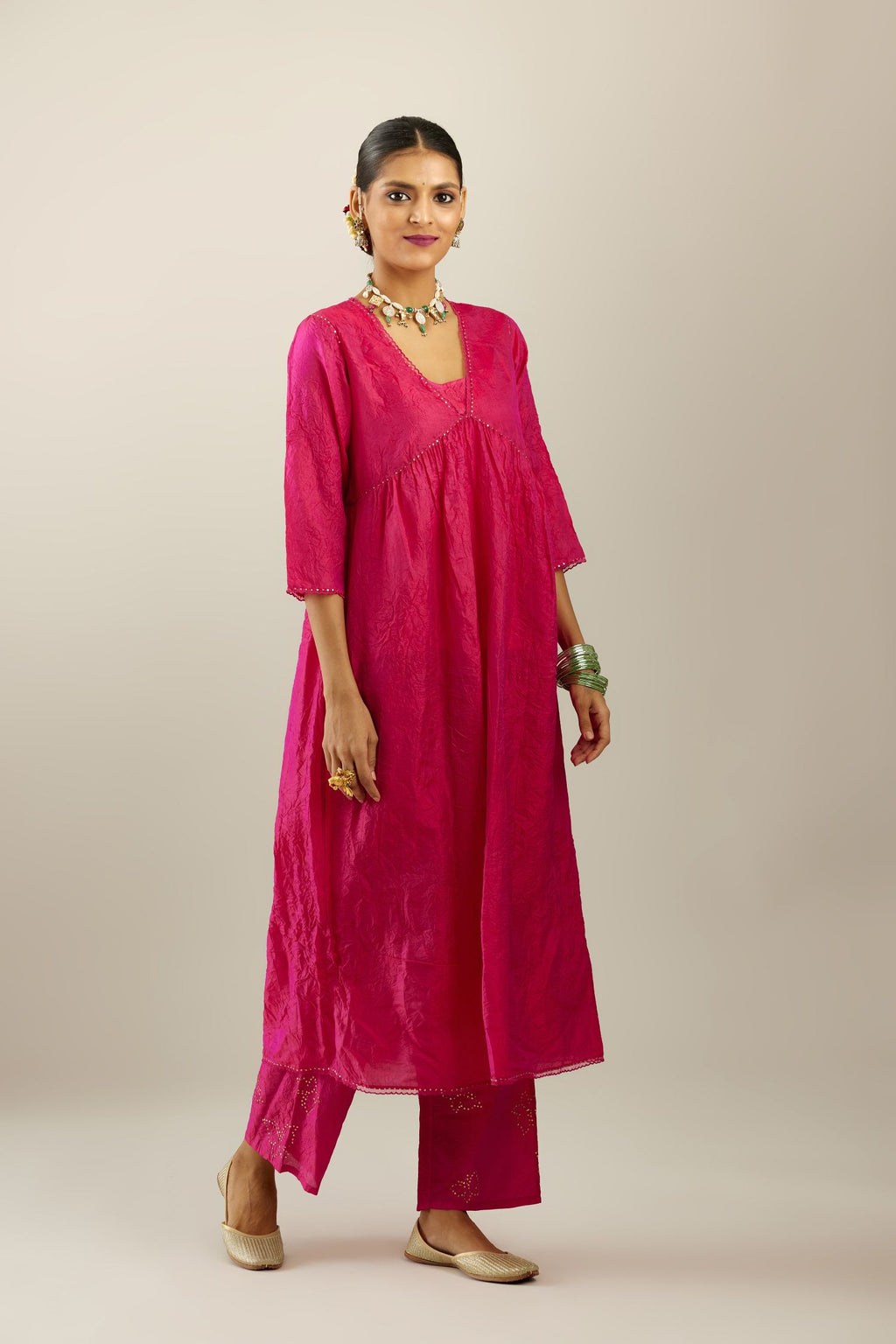 Raspberry silk hand crushed V neck gathered kurta set, highlighted with gold sequins and embroidered scalloped organza at edges.