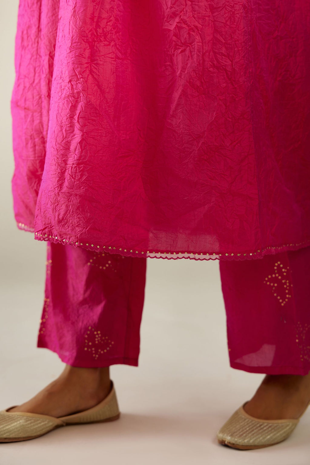 Raspberry silk hand crushed V neck gathered kurta set, highlighted with gold sequins and embroidered scalloped organza at edges.