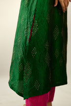 Dark green silk hand crushed A-line kurta with asymmetric hem, highlighted with all-over gold sequins diamonds, paired with raspberry  pants with scalloped and embroidered organza at edges and detailed with a single line of sequins at hem
