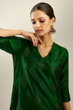 Dark green silk hand crushed A-line kurta with asymmetric hem, highlighted with all-over gold sequins diamonds, paired with raspberry  pants with scalloped and embroidered organza at edges and detailed with a single line of sequins at hem