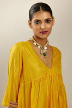 Deep yellow silk hand crushed V neck gathered kurta set, highlighted with gold sequins and embroidered scalloped organza at edges.