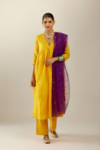 Deep yellow silk hand crushed V neck gathered kurta set, highlighted with gold sequins and embroidered scalloped organza at edges.