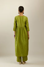 Apple green silk hand crushed V neck gathered kurta set, highlighted with gold sequins and embroidered scalloped organza at edges.