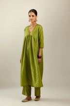 Apple green silk hand crushed V neck gathered kurta set, highlighted with gold sequins and embroidered scalloped organza at edges.