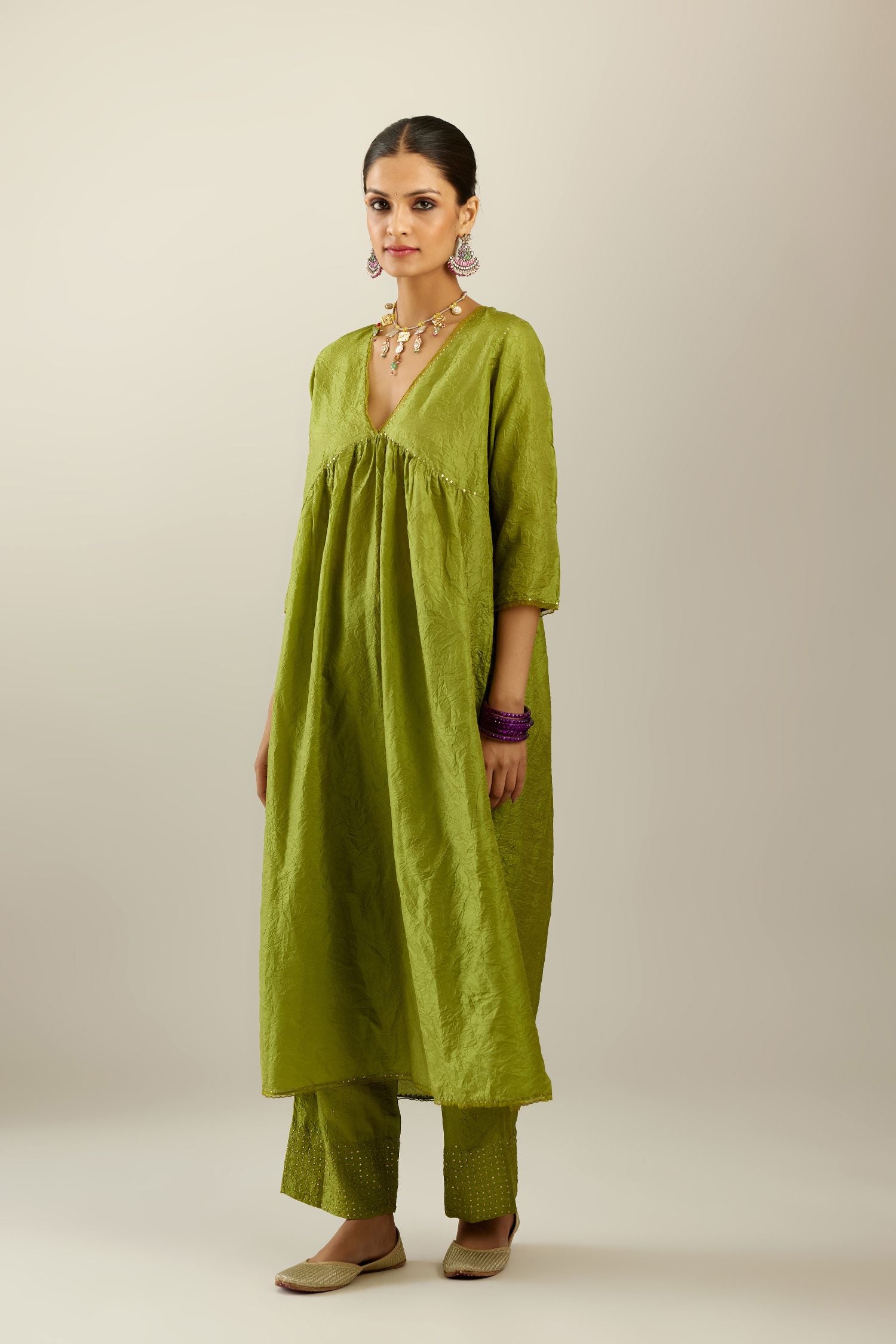 Apple green silk hand crushed V neck gathered kurta set, highlighted with gold sequins and embroidered scalloped organza at edges.