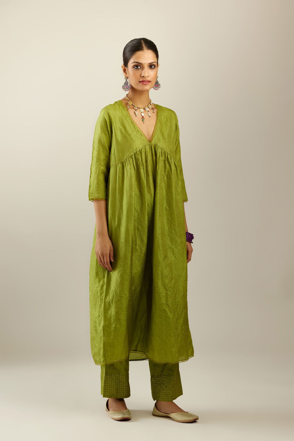 Apple green silk hand crushed V neck gathered kurta set, highlighted with gold sequins and embroidered scalloped organza at edges.