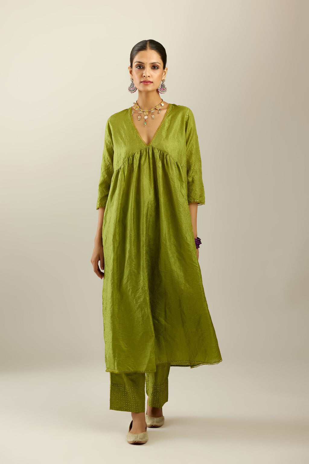 Apple green silk hand crushed V neck gathered kurta set, highlighted with gold sequins and embroidered scalloped organza at edges.