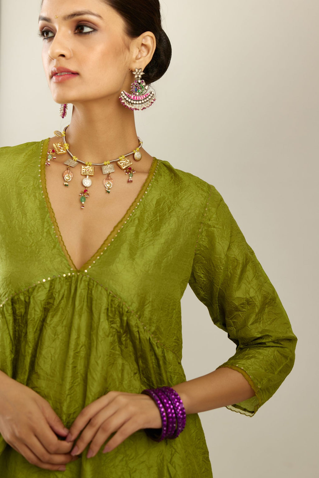 Apple green silk hand crushed V neck gathered kurta set, highlighted with gold sequins and embroidered scalloped organza at edges.
