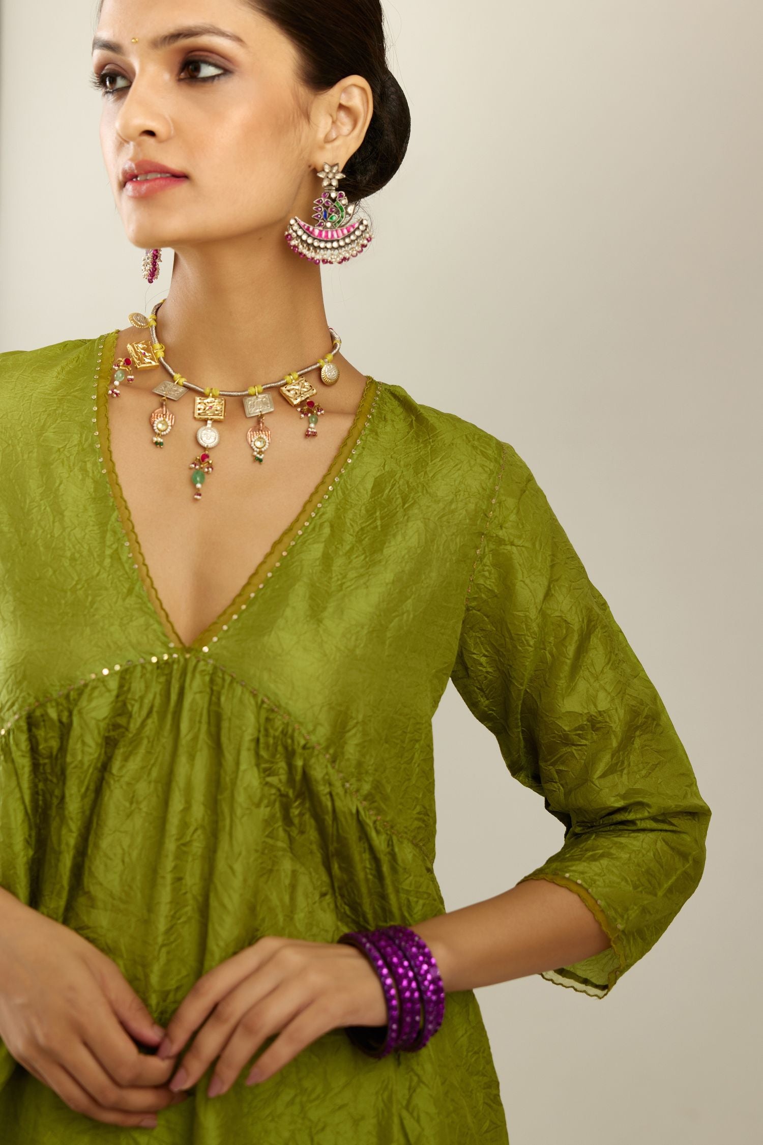 Apple green silk hand crushed V neck gathered kurta set, highlighted with gold sequins and embroidered scalloped organza at edges.