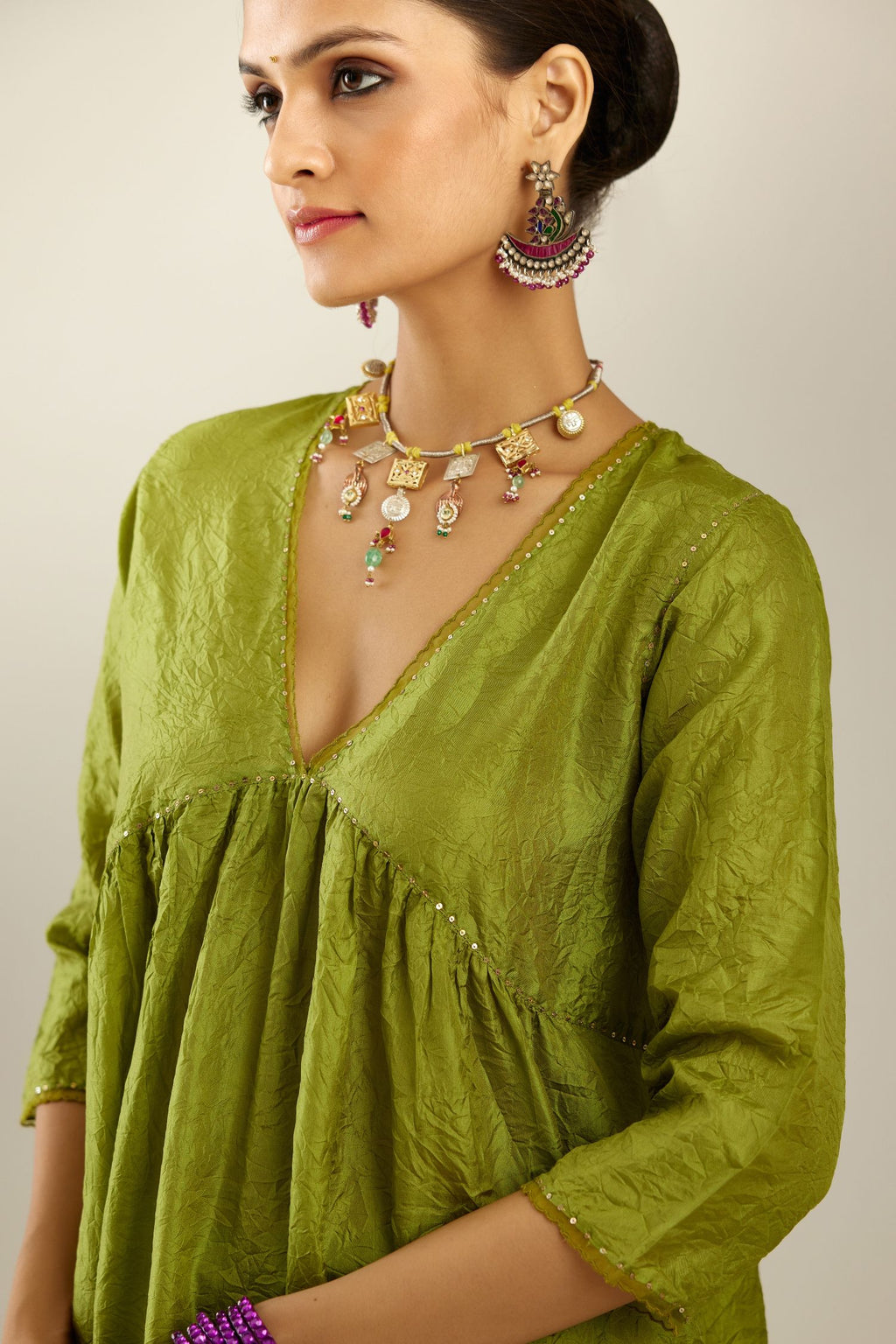 Apple green silk hand crushed V neck gathered kurta set, highlighted with gold sequins and embroidered scalloped organza at edges.