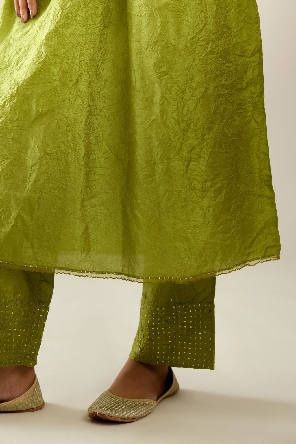 Apple green silk hand crushed V neck gathered kurta set, highlighted with gold sequins and embroidered scalloped organza at edges.
