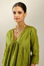 Apple green silk hand crushed V neck gathered kurta set, highlighted with gold sequins and embroidered scalloped organza at edges.