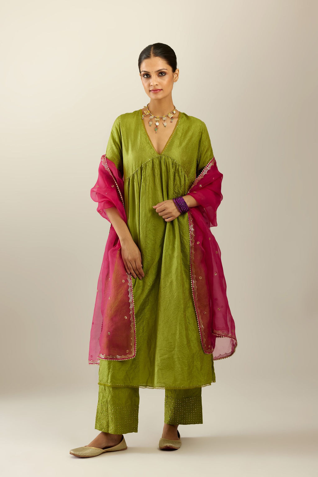 Apple green silk hand crushed V neck gathered kurta set, highlighted with gold sequins and embroidered scalloped organza at edges.