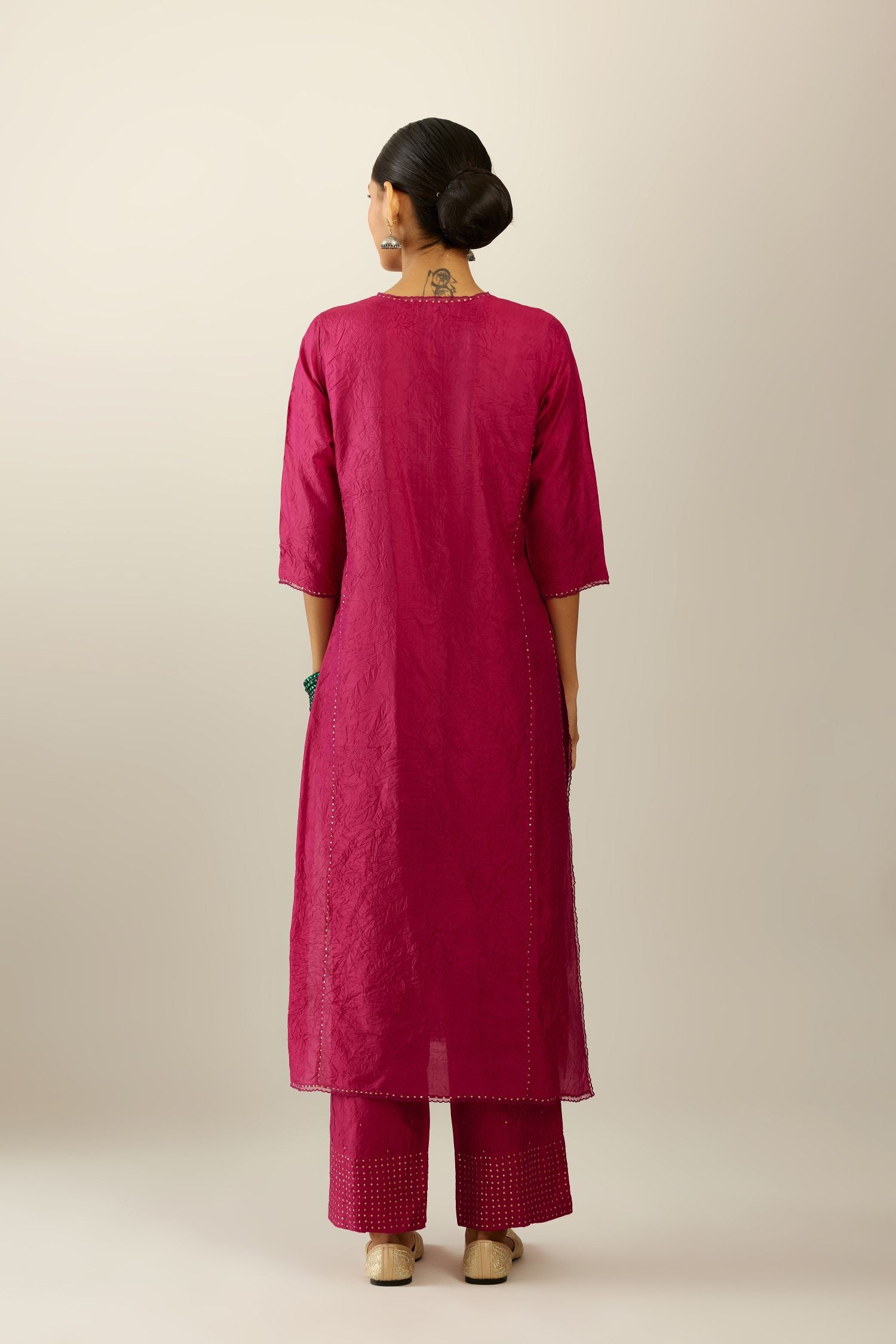 Silk hand crushed kurta set with concealed button placket neckline, highlighted with sequins and scalloped organza at edges.