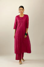 Silk hand crushed kurta set with concealed button placket neckline, highlighted with sequins and scalloped organza at edges.