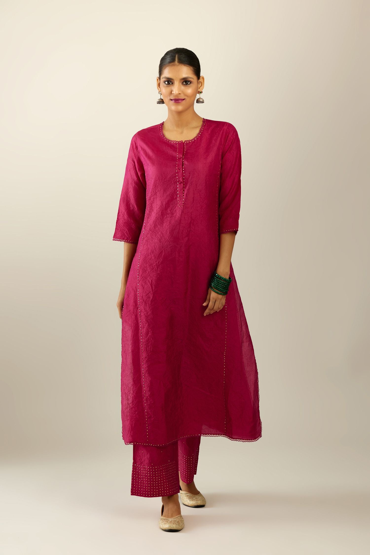 Silk hand crushed kurta set with concealed button placket neckline, highlighted with sequins and scalloped organza at edges.