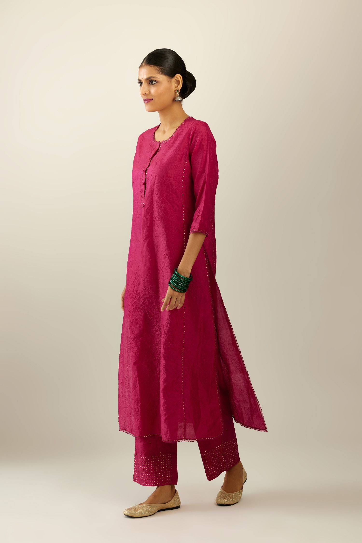 Silk hand crushed kurta set with concealed button placket neckline, highlighted with sequins and scalloped organza at edges.