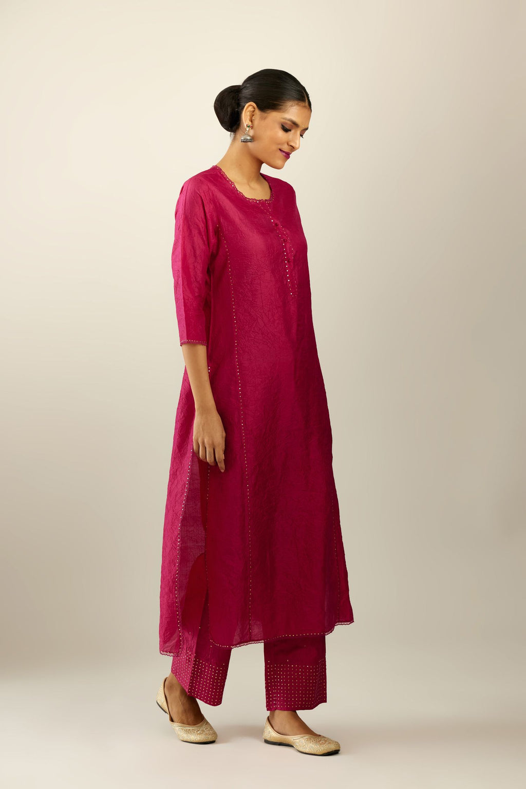 Silk hand crushed kurta set with concealed button placket neckline, highlighted with sequins and scalloped organza at edges.