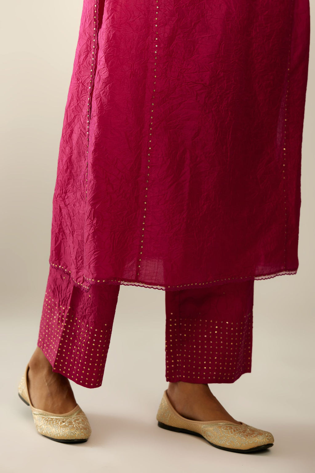 Silk hand crushed kurta set with concealed button placket neckline, highlighted with sequins and scalloped organza at edges.
