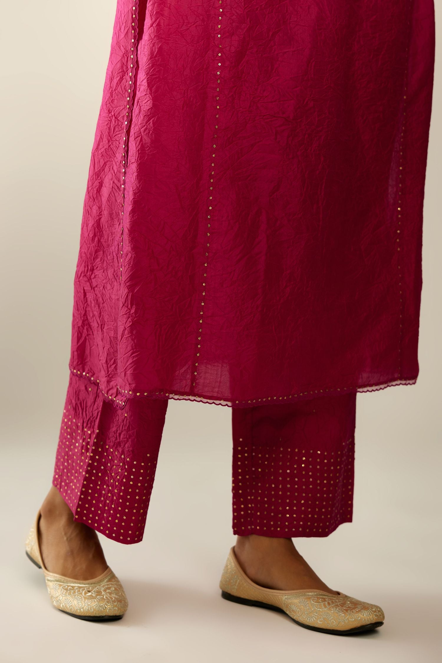 Silk hand crushed kurta set with concealed button placket neckline, highlighted with sequins and scalloped organza at edges.