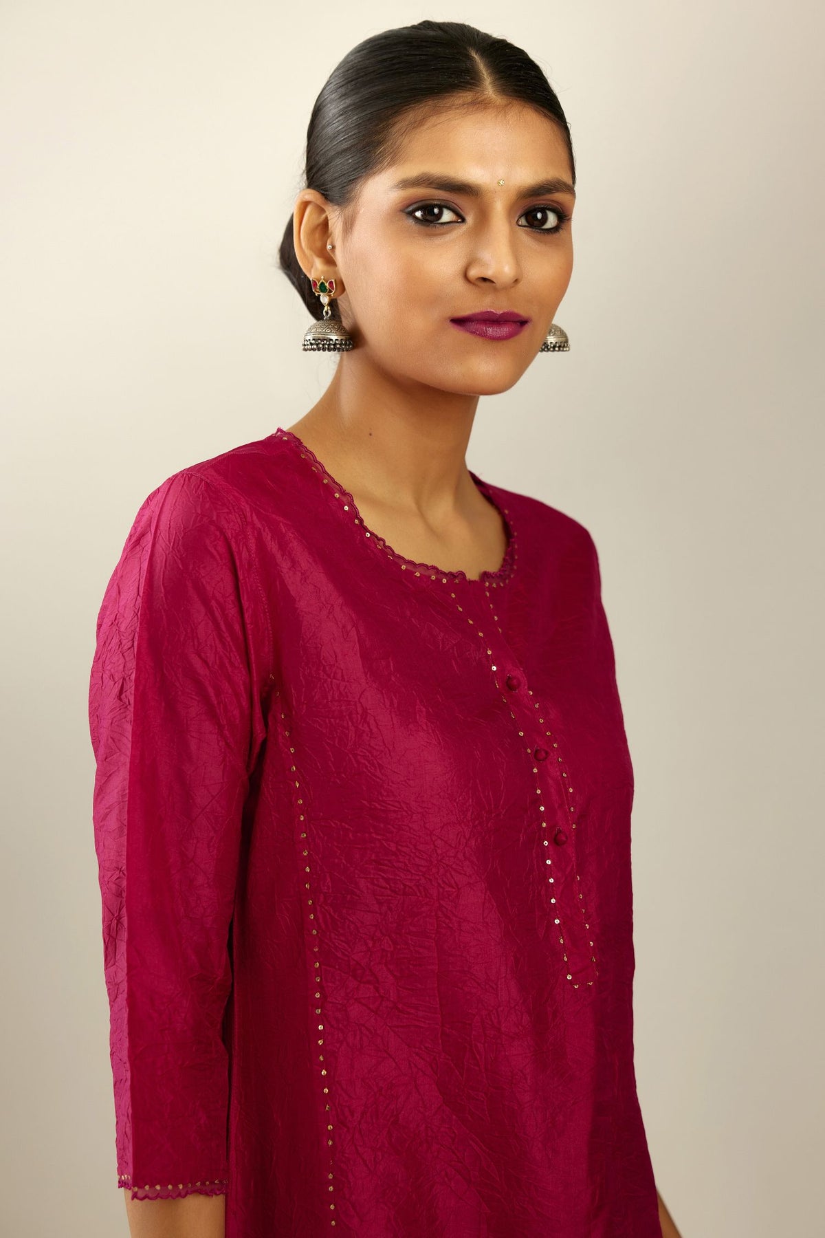 Silk hand crushed kurta set with concealed button placket neckline, highlighted with sequins and scalloped organza at edges.