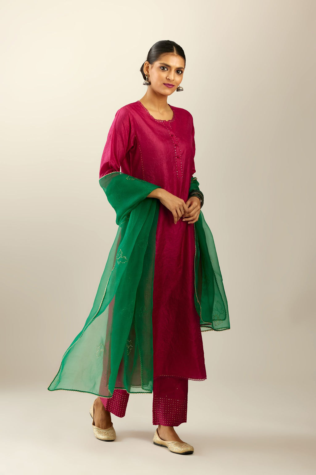 Silk hand crushed kurta set with concealed button placket neckline, highlighted with sequins and scalloped organza at edges.