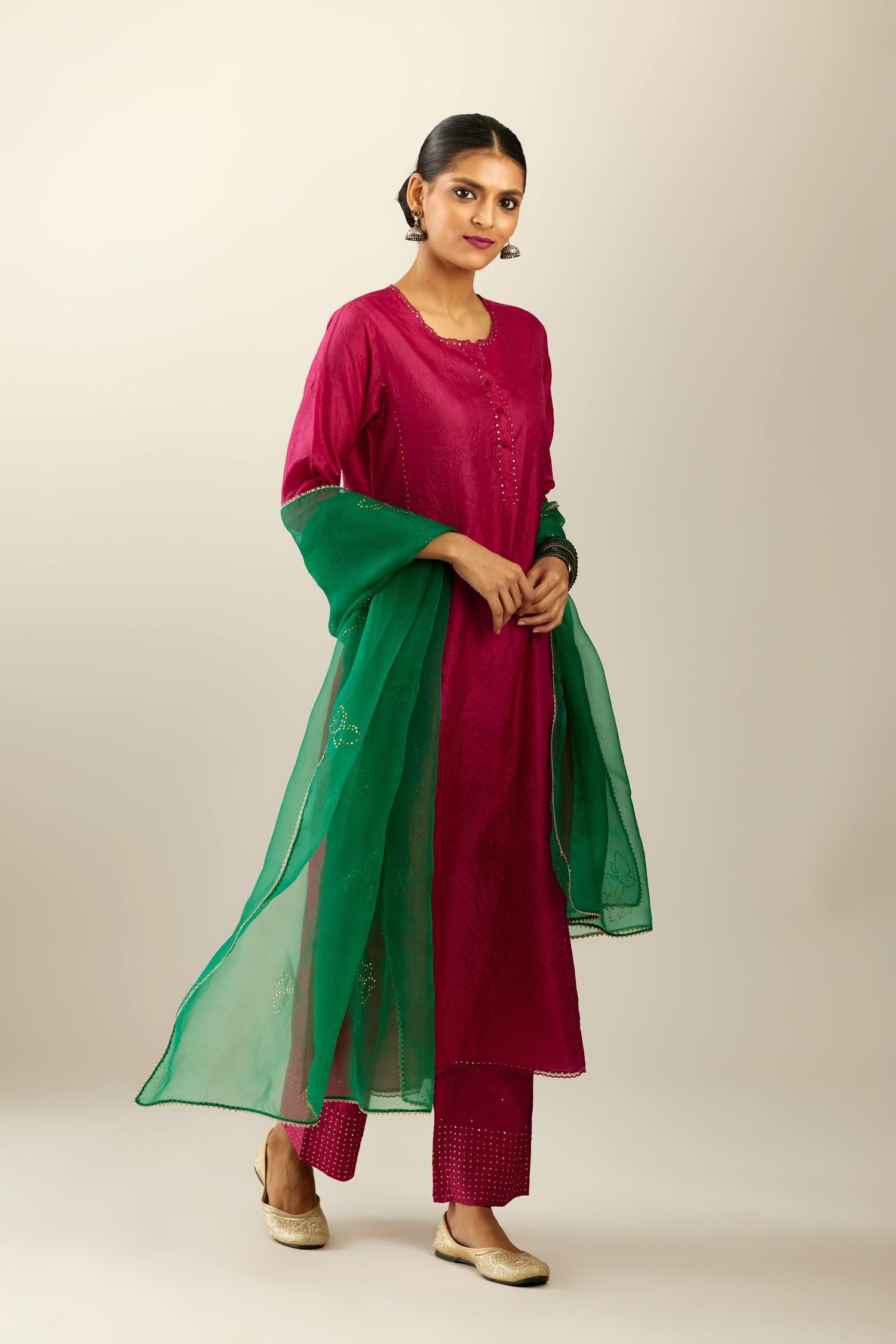 Silk hand crushed kurta set with concealed button placket neckline, highlighted with sequins and scalloped organza at edges.