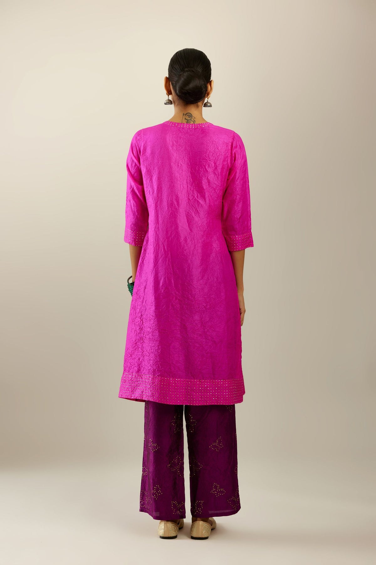 Fiji fuchsia silk hand crushed short kurta set with concealed button placket neckline, highlighted with gold sequins.