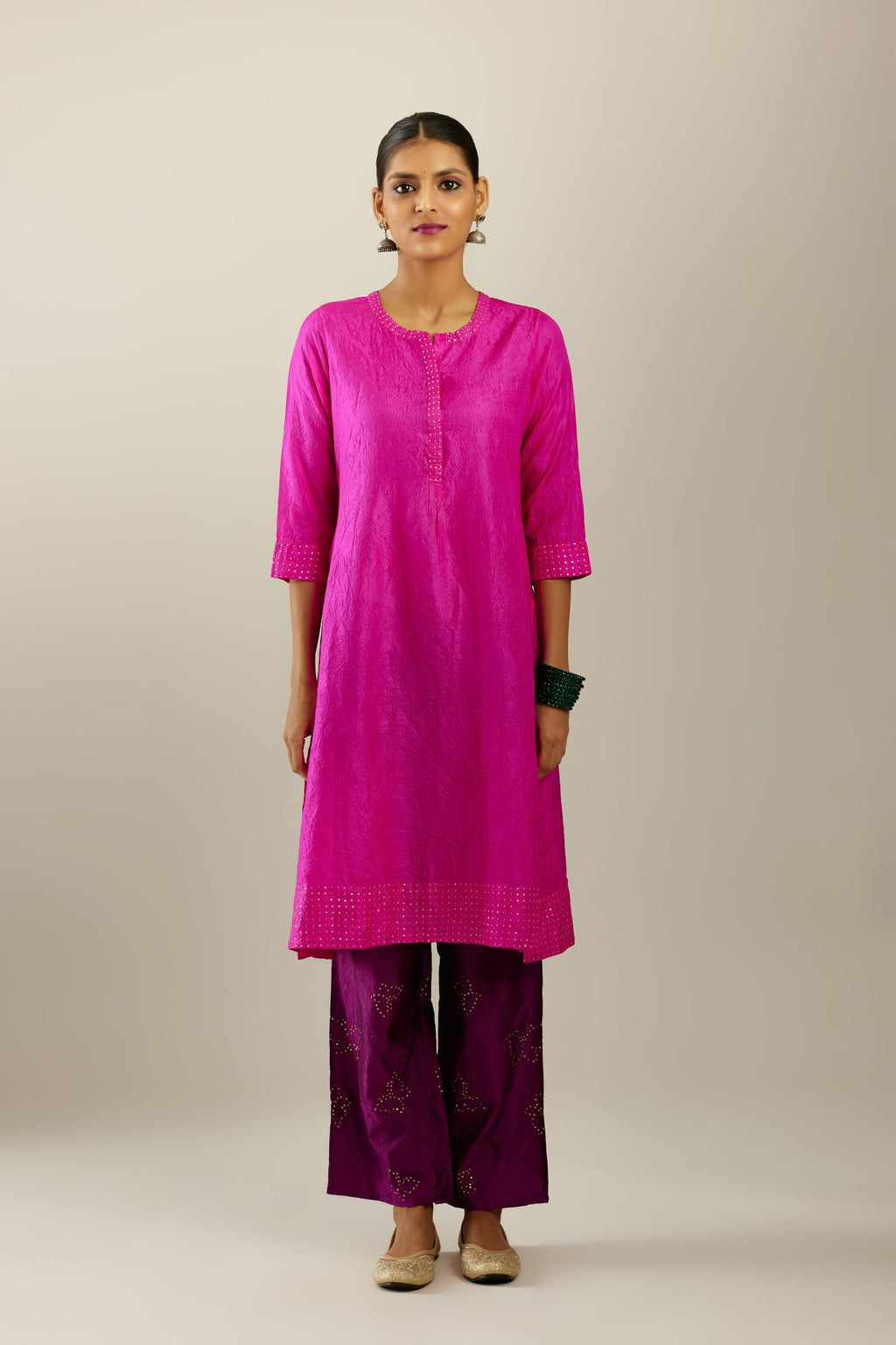 Fiji fuchsia silk hand crushed short kurta set with concealed button placket neckline, highlighted with gold sequins.