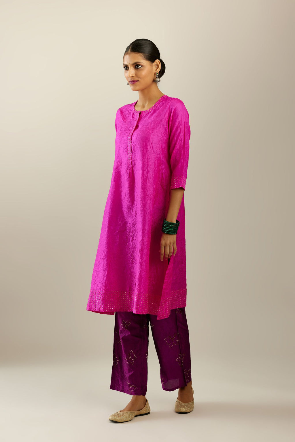 Fiji fuchsia silk hand crushed short kurta set with concealed button placket neckline, highlighted with gold sequins.
