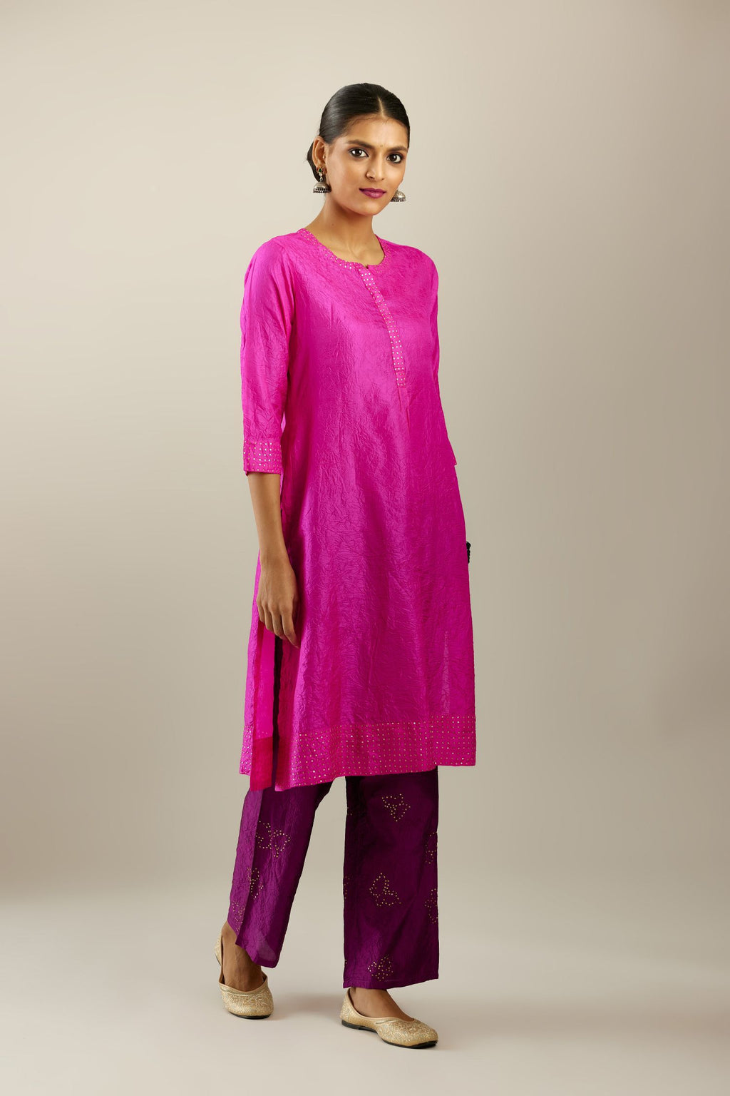 Fiji fuchsia silk hand crushed short kurta set with concealed button placket neckline, highlighted with gold sequins.