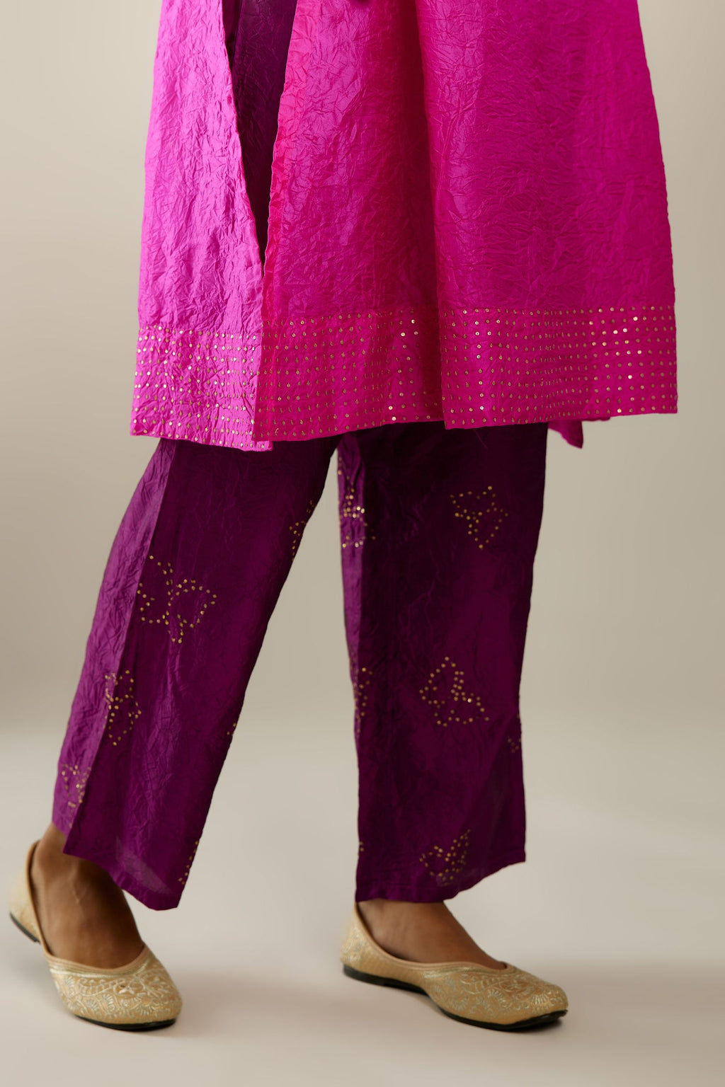 Fiji fuchsia silk hand crushed short kurta set with concealed button placket neckline, highlighted with gold sequins.
