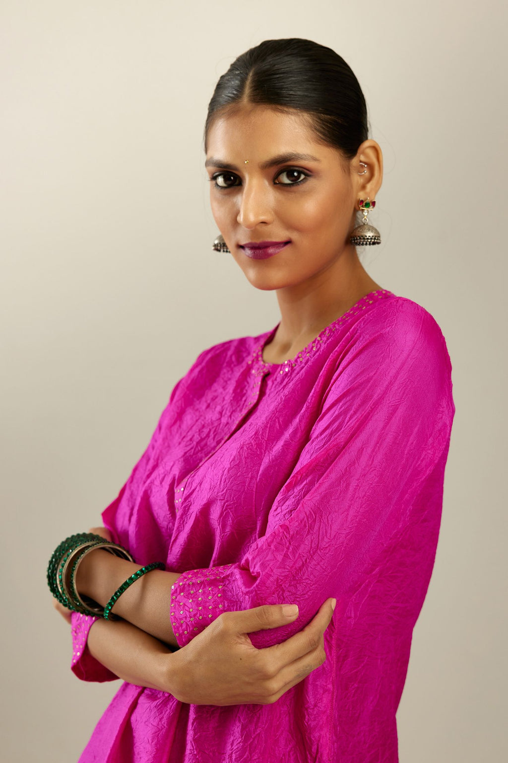 Fiji fuchsia silk hand crushed short kurta set with concealed button placket neckline, highlighted with gold sequins.