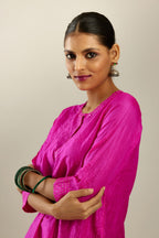Fiji fuchsia silk hand crushed short kurta set with concealed button placket neckline, highlighted with gold sequins.
