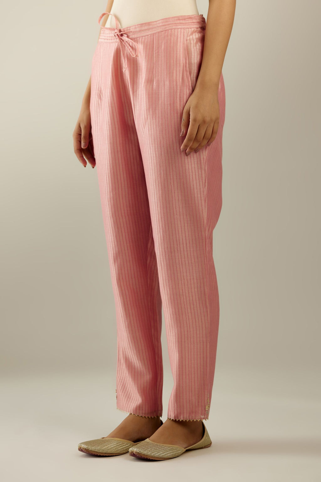 Pink striped hand block printed silk chanderi pants, highlighted with gota and zari embroidery at hem.
