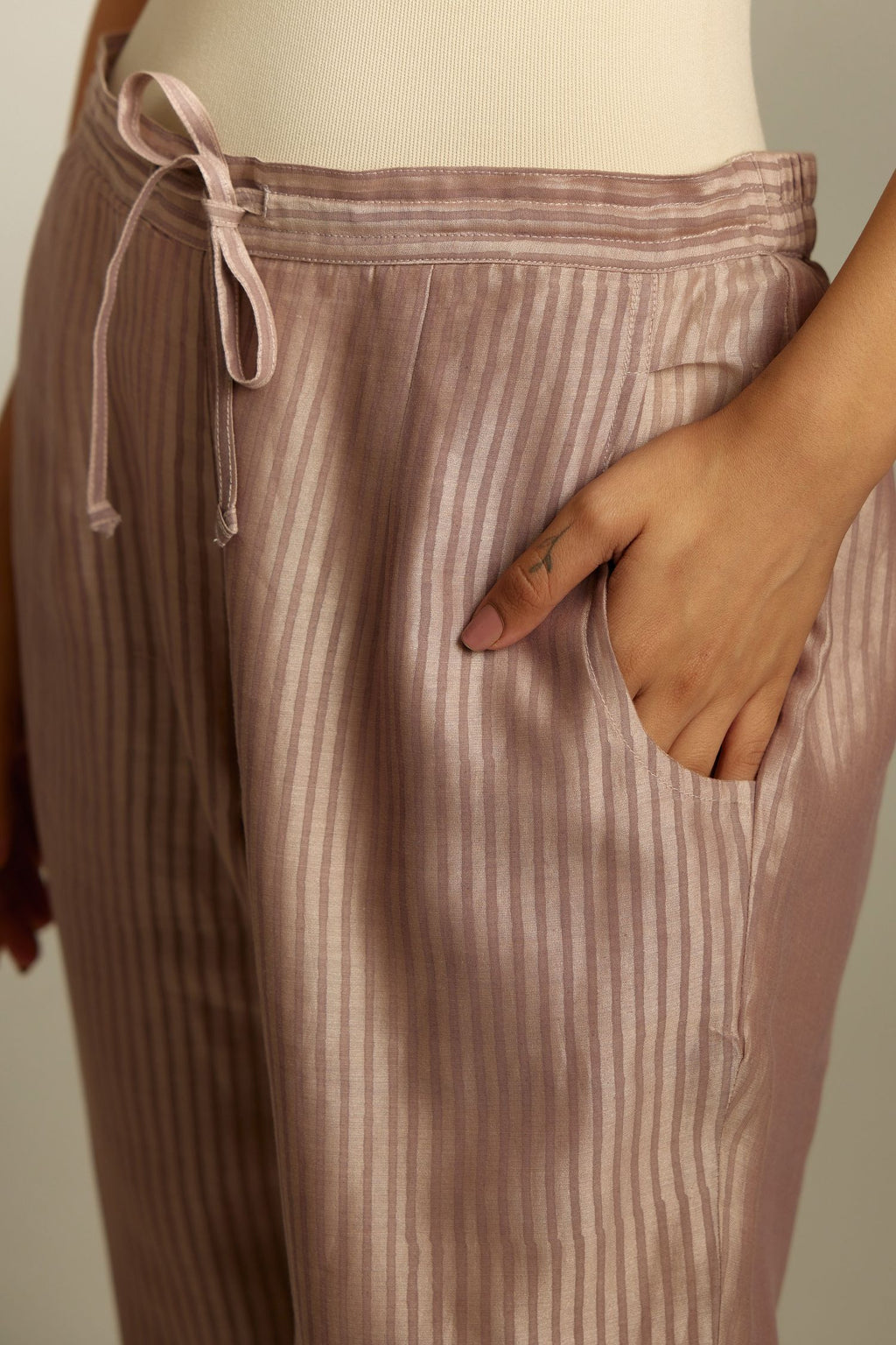 Lilac striped hand block printed silk chanderi pants, highlighted with gota and zari embroidery at hem.